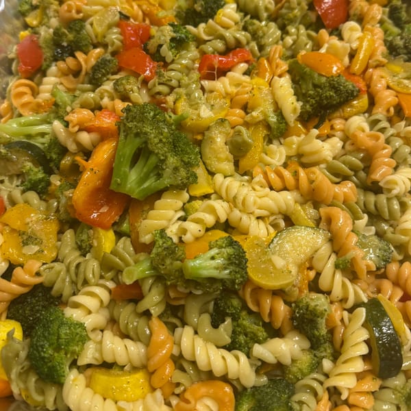 Close-up of Joe Beez deli pasta salad with tri-color rotini, broccoli, bell peppers, and zucchini.